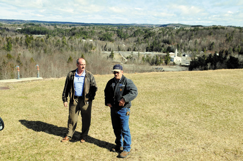 NEW STRIP: Augusta State Airport manager John Guimond, left, and maintenance director Pete Couillard confer on the spot where a proposed arrestor system is scheduled to be built on a tarmac at the facility. The project to renovate the landing strips and install arrestors is projected to cost around $7.5 million in federal grant money.