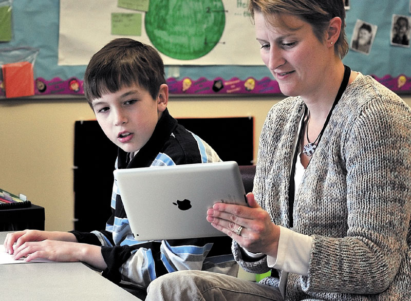 IN CLASS: Winslow Elementary School student William Weiss and speech language pathologist teacher Tanya Thibeau work during a speech class recently.