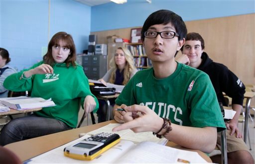 In this Tuesday, March 8, 2011 photo, Chinese student Minzhe Zou answers a question in statistics class Orono High School in Orono, Maine. Minzhe Zou has credited his year at the public school with helping him get accepted to five U.S. colleges.