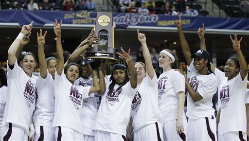Texas A&M players celebrate with the trophy after their 76-70 win over Notre Dame in the NCAA women's basketball championship game Tuesday in Indianapolis.