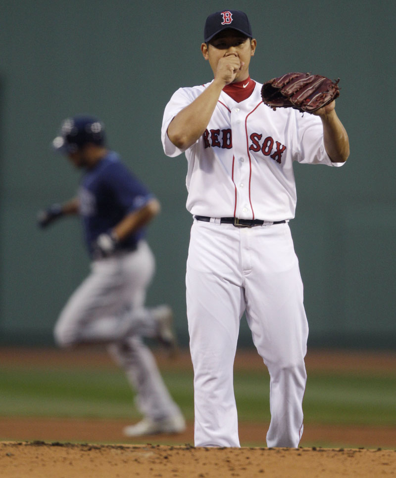 TOUGH NIGHT: Red Sox pitcher Daisuke Matsuzaka waits for a fresh ball as Tampa Bay outfielder Johnny Damon rounds the bases on a solo home run during the first inning of a 16-5 loss Monday night at Fenway Park in Boston. Matsuzaka gave up seven runs on eight hits in only two innings. That included six runs during the second inning before recording an out.