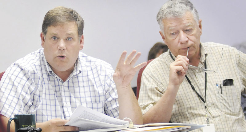 Maine's Chief Boiler, Elevator, and Tramway Inspector, John Burpee, center, answers questions Monday about his investigation of the Sugarloaf tramway collapse during a meeting of the Elevator and Tramway Safety Board in Gardiner. Burpee and inspector Stanley Quinn, right, investigated the cause of the collapse.