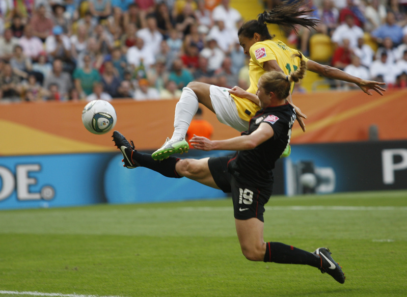 Rachel Buehler of the United States fouls Brazil's Marta, top, during today's quarterfinal at the Women's Soccer World Cup in Dresden, Germany.