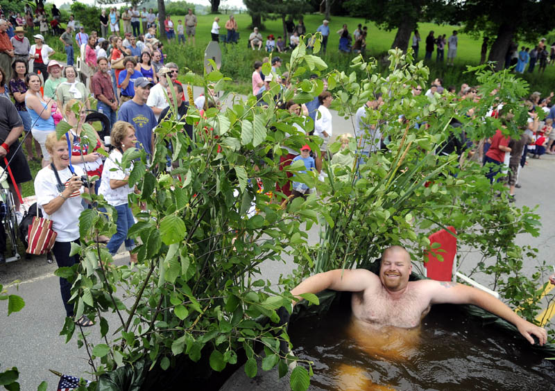 FLOATING ALONG: Ben Harmon floats Monday through Kings Mills in Whitefield during the annual Fourth of July parade. Several hundred people crowded the roads to watch the pageantry and patriotism.