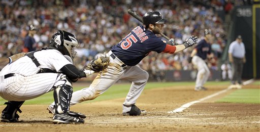 Boston's Dustin Pedroia (15) hits a two-run single in the seventh inning of the Red Sox' 7-5 win over the Astros on Friday in Houston.