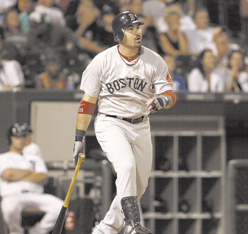 IT’S GONE: Boston’s Adrian Gonzalez watches his two-run home run in the ninth inning that gave Boston a 7-2 lead against the Chicago White Sox on Saturday in Chicago.