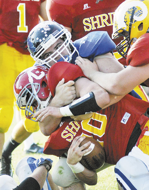 TAKEDOWN: West’s Michael Burgess of Greely High School puts a hit on East quarterback Luke Duncklee of Cony High School during the Lobster Bowl on Saturday in Biddeford.