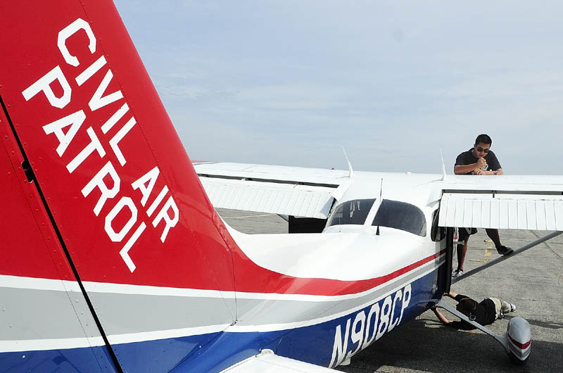 Civil Air Patrol cadets Michael Chung, of San Diego, top, and Eamonn Fitzpatrick, of Lumberton, N.J., do a pre-flight check on one of the planes they’re using for training on Tuesday at the Augusta State Airport.