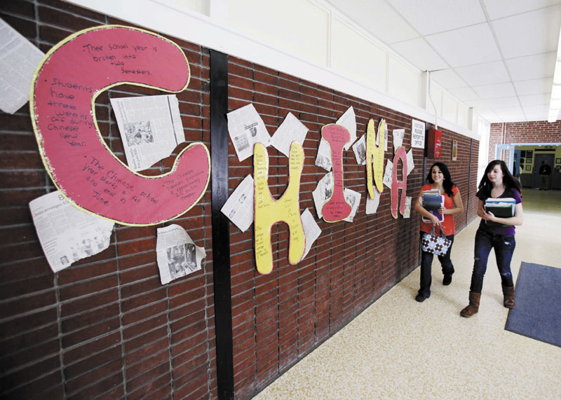 CHINA: In this March 10 photo, students walk past a display at Stearns High School in Millinocket. The public high school recruited students from China to help boost enrollment and revenues. But only six Chinese students will attend high school in fall 2011 after the school district's recruitment effort fell far short of its enrollment goal of 60.