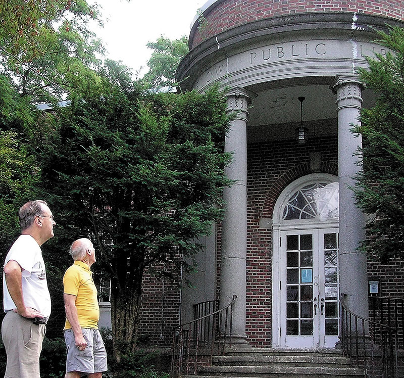 HISTORIC LIBRARY: Bob Chenard, left, and Fred Clark, members of the Taconnett Falls Chapter of the Maine Genealogical Society, are seen Friday at the town-owned Lithgow Street library, where the organization is headquartered. Winslow town officials have decided to spend $15,000 to replace the roof of the 84-year-old building and are expected to later discuss whether to sell it.