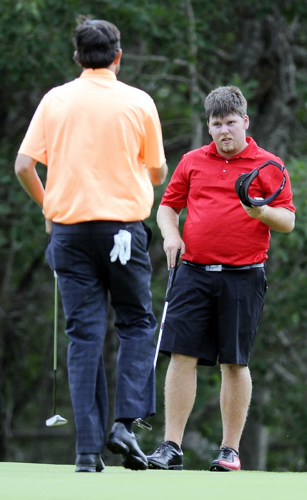 THE CHAMP: Ryan Gay, right, takes his cap off Thursday as Matt Greenleaf concedes on the 16th hole during the final round of the MSGA Match Play Invitational at the Augusta Country Club in Manchester.