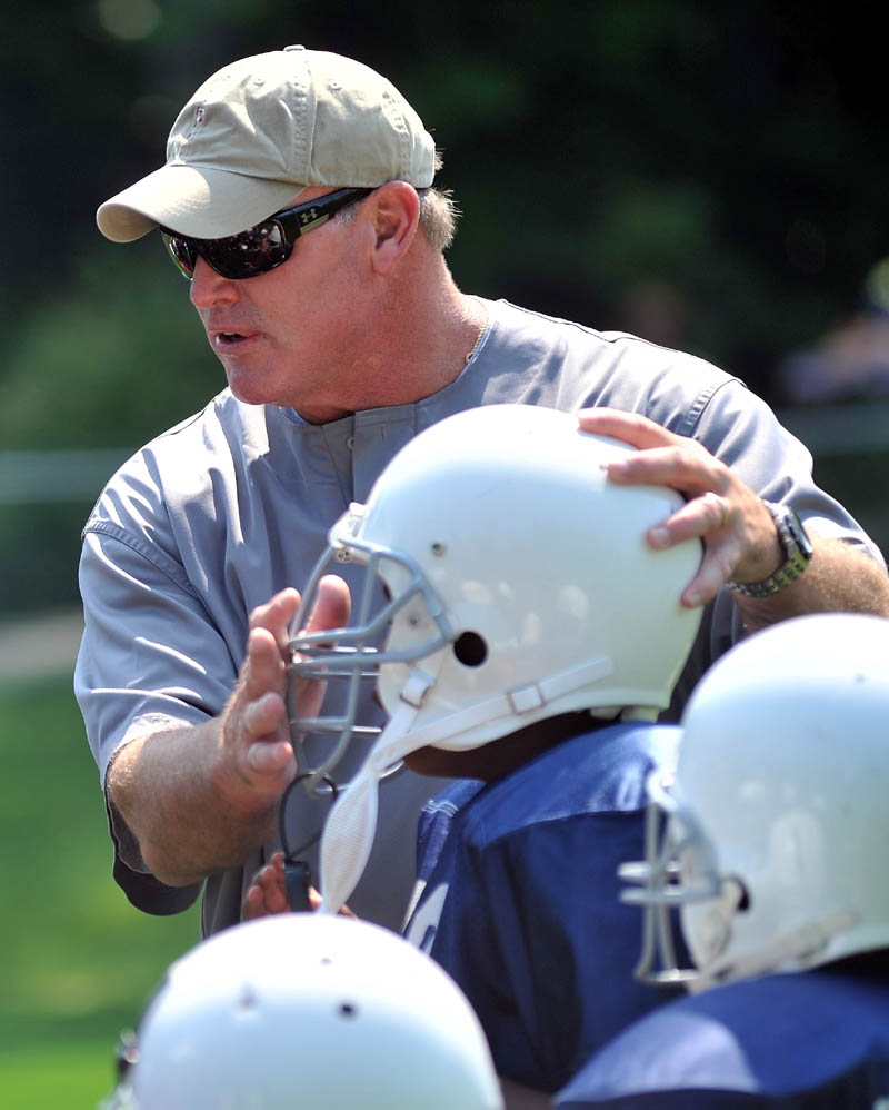 Former New York Jets defensive lineman Marty Lyons works with a group of local football players at Camp Tracy in Oakland Friday.