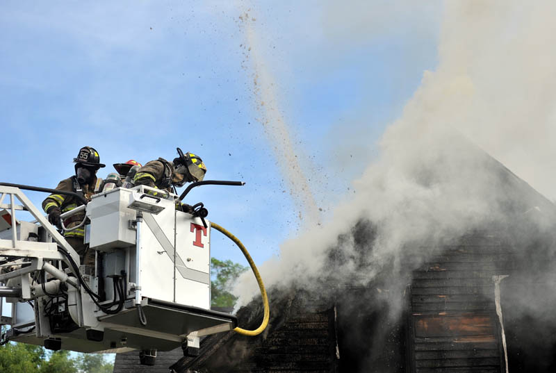 Staff photo by Michael G. Seamans Forty firefighters from four agencies including Waterville, Winslow, Fairfield and Oakland Fire Departments, responded to a house fire on Oak Street in Waterville Tuesday morning. No injuries were reported.