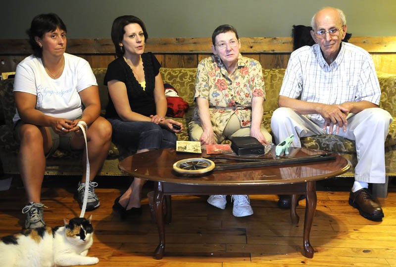 SURVIVORS: Harold and Marlene, second from right, Webber lost their Mount Vernon home to a fire last week. The home is where they raised their daughters, Emily Webber, left, and Joyce Jones. A lightning strike destroyed the old schoolhouse that the Webbers have occupied since 1969. Neighbors and friends have helped them find and save items from the home.