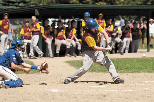 LOW FASTBALL: Franklin County's Robbie Matteson goes after a low fastball against Braintree, Mass. during the New England Babe Ruth Regional Championship tournament Sunday afternoon at Hippach Field in Farmington.