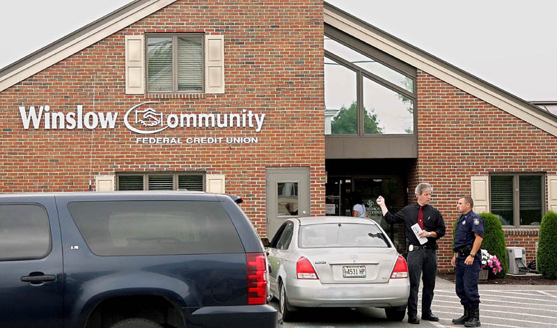 Winslow Police Chief Jeffrey Fenlason talks with a state police officer following a robbery at the Winslow Community Federal Credit Union on Monument Street Thursday morning.