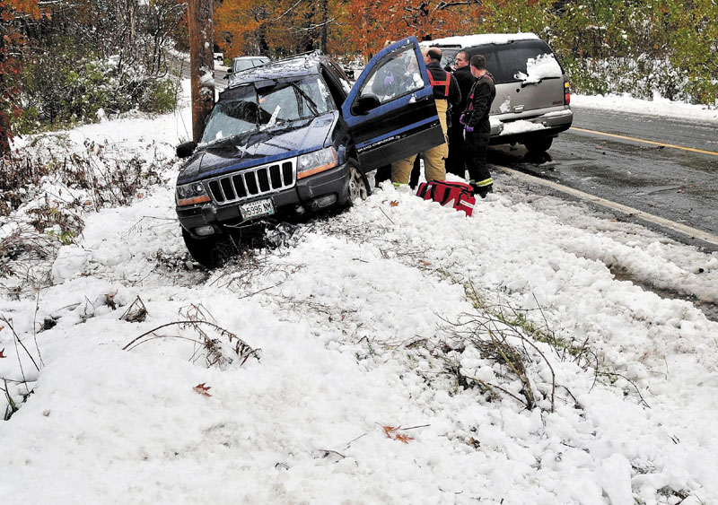 SURPRISE: The driver of this vehicle is checked after sliding in slush and snow on the Cushman Road in Winslow on Sunday and striking a utility pole. Police say the driver was not injured.