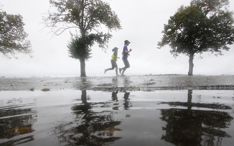 Melissa Wells, right, and Meghan Slattery, both of New Brunswick, Canada, near the finish line of the Maine Marathon in Portland today. They were among 3,500 runners who entered to run in the marathon, half-marathon and relay.