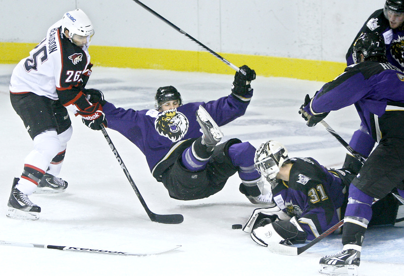 Mathieu Beaudoin of the Pirates, left, upends Cam Paddock of the Manchester Monarchs as Monarchs goalie Martin Jones knocks the puck away in the first period of the hockey exhibition game today at the Cumberland County Civic Center.