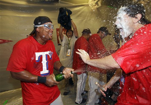 Texas Rangers' third baseman Adrian Beltre, left, sprays Ian Kinsler as they celebrate after winning the ALCS on Saturday in Arlington Texas.