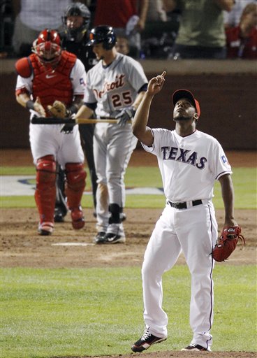 Texas Rangers' Neftali Feliz reacts after striking out Detroit Tigers' Ryan Raburn for the final out of Game 1 at baseball's American League championship series Sunday, Oct. 9, 2011, in Arlington, Texas. Texas won, 3-2. Texas catcher Mike Napoli and home plate umpire Tim Welke are at rear. (AP Photo/Eric Gay)