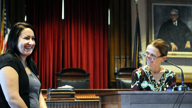 Nichole Rogers, left, laughs as Kennebec County Superior Court Justice Nancy Mills recognizes her Monday during a graduation ceremony in Augusta for the Co-Occurring Disorders Court. Rogers, of Augusta, was enrolled in the program for two years after being charged with several crimes. She had to tackle mental health and substance abuse problems. Seven people graduated from the program Monday.