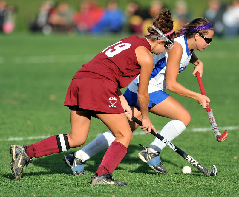 Lawrence High School's Danielle Armour, right, battles for the ball with Edward Little High School's Kayla Nadeau in the second half of Eastern A quarterfinals game at Lawrence High School in Fairfield Tuesday. Lawrence defeated Edward Little 2-0.