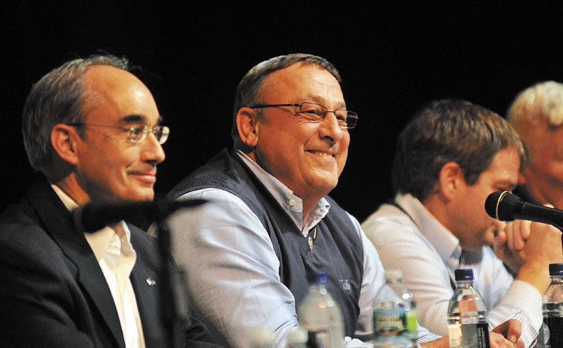 Gov. Paul LePage, center, takes questions from the audience during a town hall style meeting at Mount View High School in Thorndike on Thursday night. The meeting was part of his continuing Capitol for a Day tour of the state. Seated to LePage’s left is state treasurer, Bruce Poliquin.