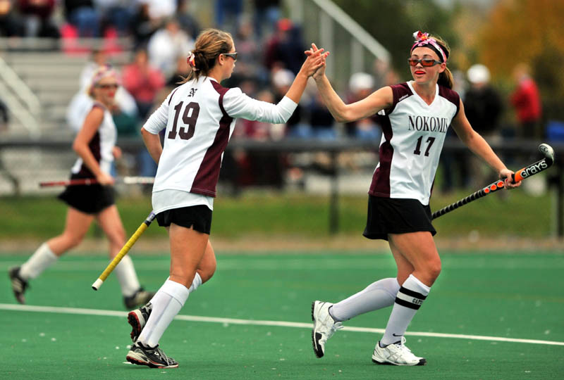 HIGH FIVE: Nokomis’ Marissa Shaw, right, celebrates with teammate Leah Edmondson after Edmondson’s second goal of the first half against Belfast High School in the Kennebec Valley Athletic Conference Class B championship game Wednesday at Colby College in Waterville.