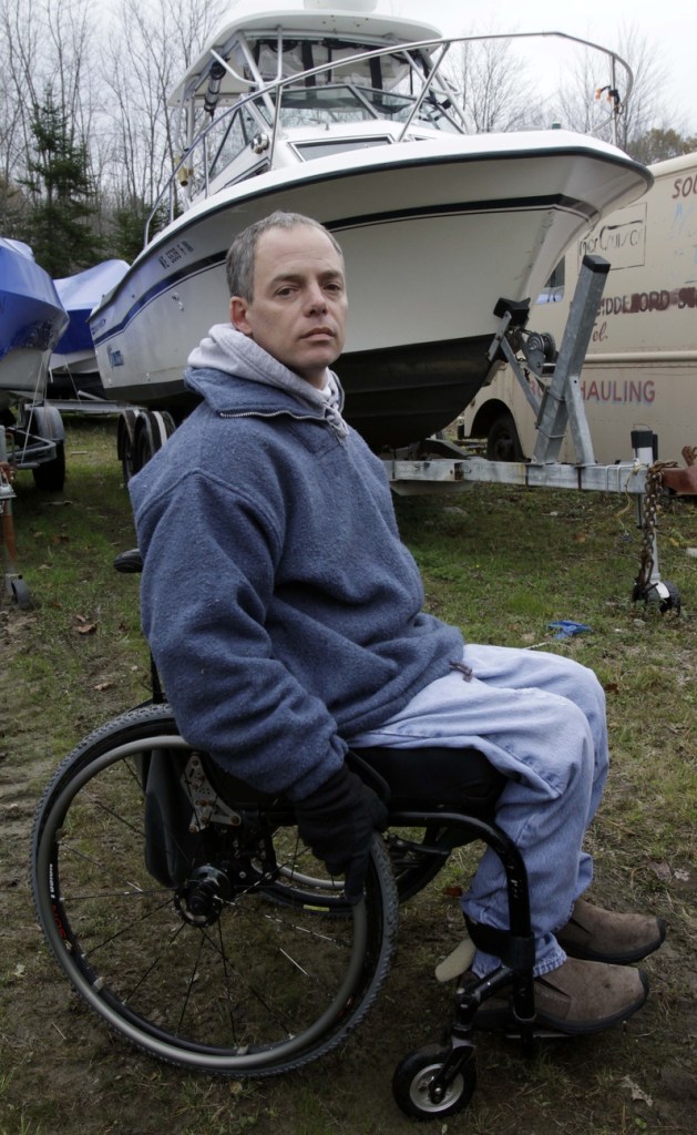 Nick Masi III poses in front of his boat, in the background, at a boatyard in Arundel, Maine. Masi lost more than his boat and his best friend when his boat capsized while fishing for bluefin tuna in rough waters off the Maine coast last month. His dreams were also shattered of starting his own charter fishing boat business and getting his life on track four years after being paralyzed from the waist down in a construction accident.