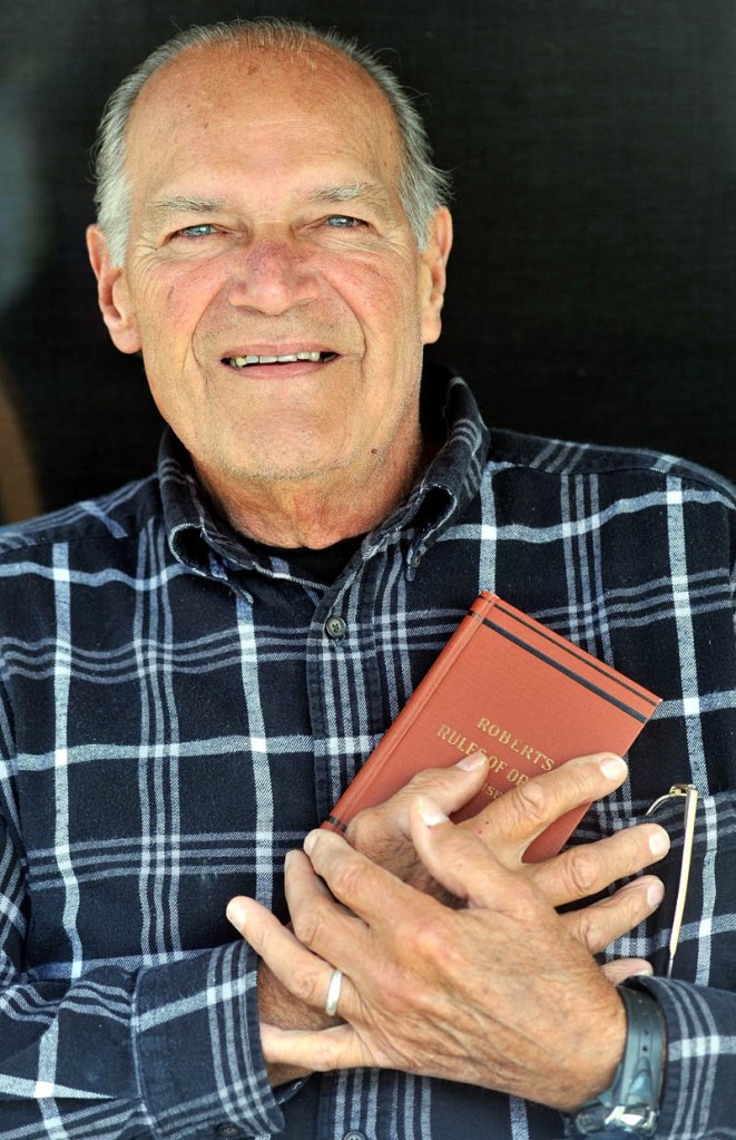 LONGTIME PUBLIC SERVANT: Ronald Michaud poses for a portrait at his Winslow home Wednesday afternoon.