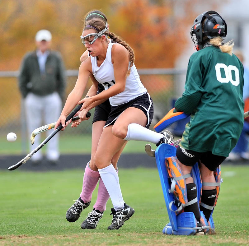 Staff photo by Michael G. Seamans Skowhegan Area High School's Makaela Michonski, 21, center, collides with Brunswick High School defender Olivia LeRoy, 4, in front of Brunswick goalie Sydney Escoe, 00, in the second in an Eastern A regional quarterfinal game at Skowhegan Area High School Wednesday afternoon. Skowhegan defeated Brunswick 6-0.