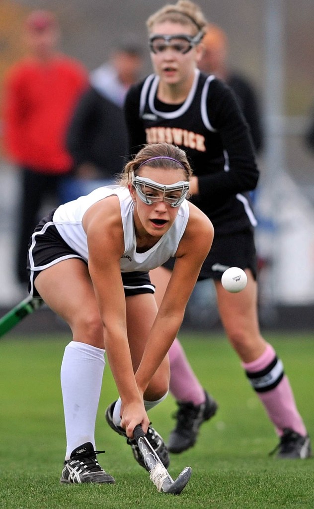 Staff photo by Michael G. Seamans Skowhegan area High School's Makaela Michonski, 21, plays the ball in the second half against Brunswick High School in an Eastern A regional quarterfinal game at Skowhegan Area High School Wednesday afternoon. Skowhegan defeated Brunswick 6-0.