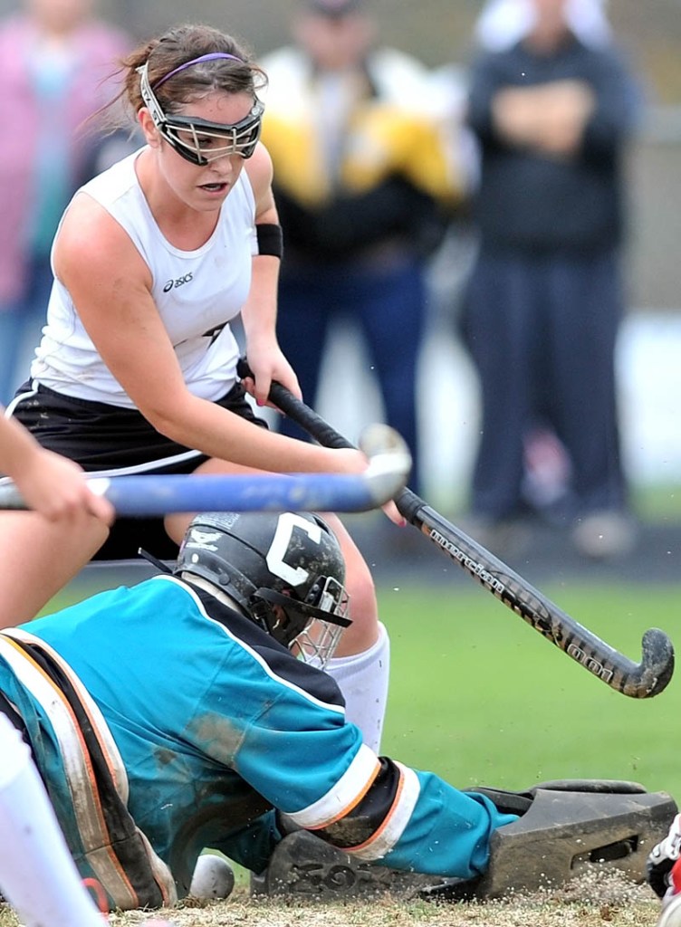 WORKING HARD: Skowhegan Area High School’s Jessica Skillings, back, tries to get a shot past Cony High School goalie Kevie Rodrigue in the Eastern A semifinals Saturday in Skowhegan.