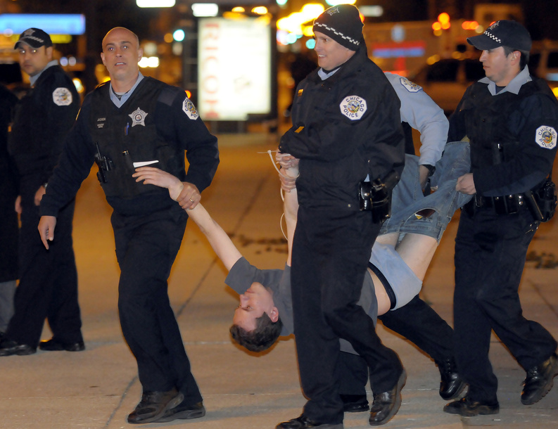 Chicago police carry away a protester at the Global Day of Occupation-Chicago March to Michigan and Congress, early today in Chicago. Police arrested 175 members of a group protesting corporate greed early today after they refused to take down their tents and leave a city park when it closed.