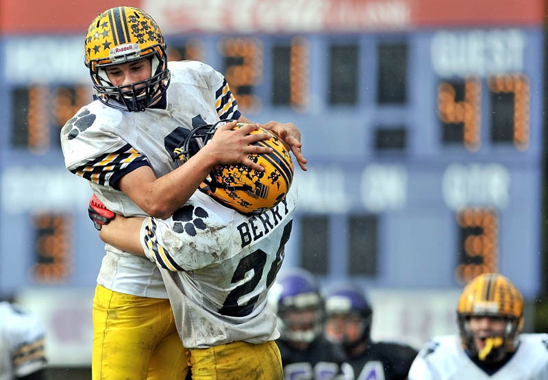 WAY TO GO: Mt. Blue High School’s Bradley Jackson, left, celebrates with teammate Eric Berry after Jackson returned an interception for a touchdown against Waterville Senior High School on Saturday at Drummond Field in Waterville. Mt. Blue defeated Waterville 55-14.