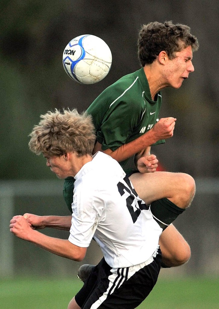 Staff photo by Michael G. Seamans Mt. View High School's Trevor Diemer, 7, top, battles for the ball with Winslow High School's Graham Clark, 25, in the second half in an Eastern B quarterfinal game at Kennebec Savings Bank Field in Winslow. Mt. View won 3-0.