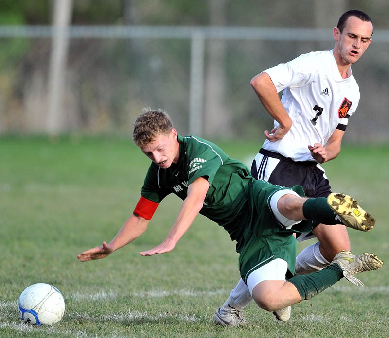 Staff photo by Michael G. Seamans Mt. View High School's Aaron Elkins, 1, gets knocked to the ground by Winslow High School's Finn Ducker, 7, in an Eastern B quarterfinal game at Kennebec Savings Bank Field in Winslow. Mt. View won 3-0.