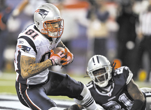 GAME-WINNER: New England Patriots tight end Aaron Hernandez (81) catches a touchdown pass as Dallas Cowboys cornerback Mike Jenkins (21) watches late in the fourth quarter Sunday in Foxborough, Mass.