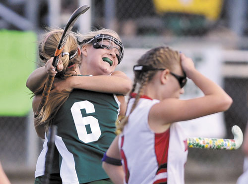 WE DID IT: Winthrop High School’s Mary Claire Blanchard, facing, celebrates with teammate Lauren Kaiser (6) after Kaiser scored a goal in the second half against Dexter Regional High School in the Eastern Class C regional championship game Tuesday at Hampden Academy.