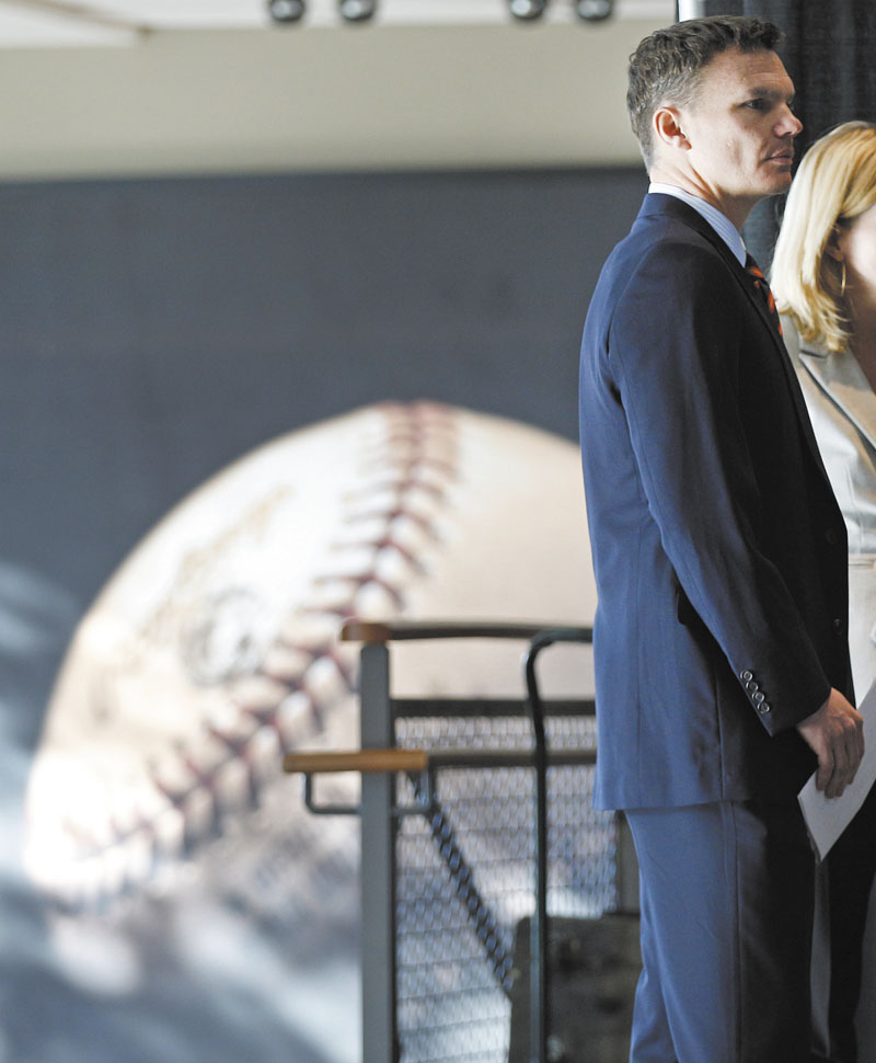 STEPPING UP: Ben Cherington waits to be introduced as the general manager of the Boston Red Sox on Tuesday at Fenway Park. Cherington takes over for Theo Epstein, who was introduced as president of baseball operations of the Cubs on Tuesday.