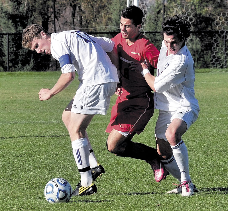Thomas College’s Michael Hand, center, battles for the ball with Colby’s Cory Hendrickson, left, and Andrew Meisel during the Elm City Bowl on Tuesday in Waterville. Meisel scored with 1 minutes, 51 seconds left in the first overtime to lift the Mules to a 1-0 win.