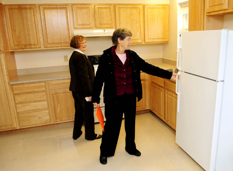 REVAMPED COMPLEX: Rep. Anna Blodgett, D-Augusta, left, and MaineHousing Director Dale McCormick check out one of the newly renovated units at the Greentree Apartments on New England Road in Augusta.