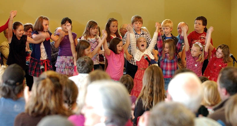 TAKING A BOW: Third-graders bow after singing in front of hundreds of onlookers Saturday morning during an open house and dedication of the new W.G. Mallett School in Farmington.
