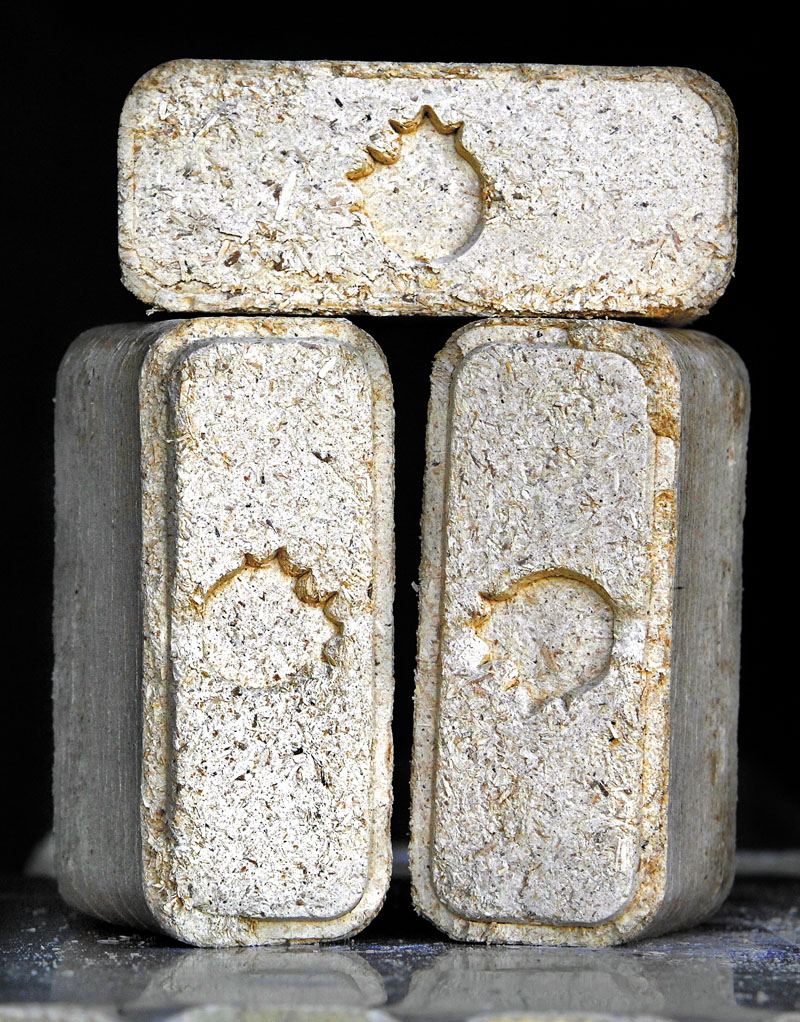 Compressed wood fuel, or wood bricks, like the ones scene here at the Maine Biomass warehouse in Brunswick, are arriving on the alternative energy scene in Maine.