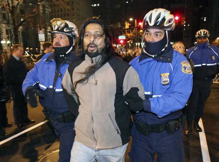 Police arrest a member of Occupy Philly this morning as they began pulling down tents and telling demonstrators they had to leave.