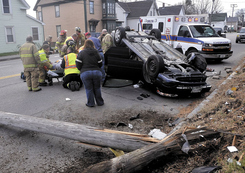 Fairfield firefighters and paramedics from Delta Ambulance treat a victim involved in an accident that sheared a utility pole on College Avenue in Fairfield on Saturday morning.