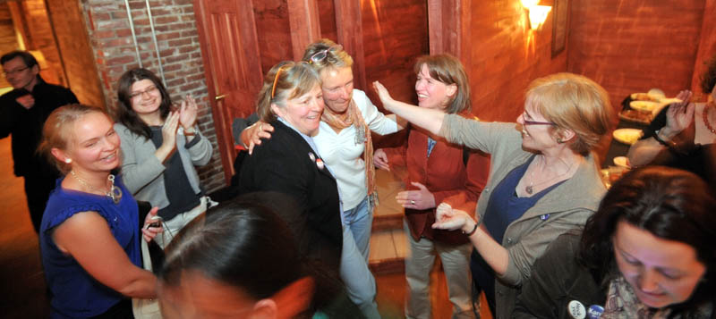 Mayor-elect Karen Heck, center, celebrates with supporters at 18 Below Raw Bar in Waterville Tuesday night after poll results filtered in.