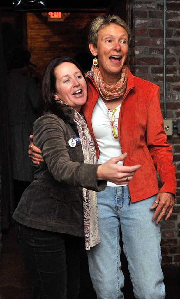 Mayor-elect Karen Heck, right, stands with her campaign manager Dana Hernandez, left, at 18 Below Raw Bar in Waterville Tuesday night.