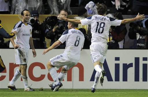 Los Angeles Galaxy forward Landon Donovan, left, celebrates his goal with teammates midfielder Chris Birchall, center, and forward Mike Magee during the second half of their MLS Cup championship soccer match against the Houston Dynamo, Sunday in Carson, Calif. The Galaxy won 1-0.